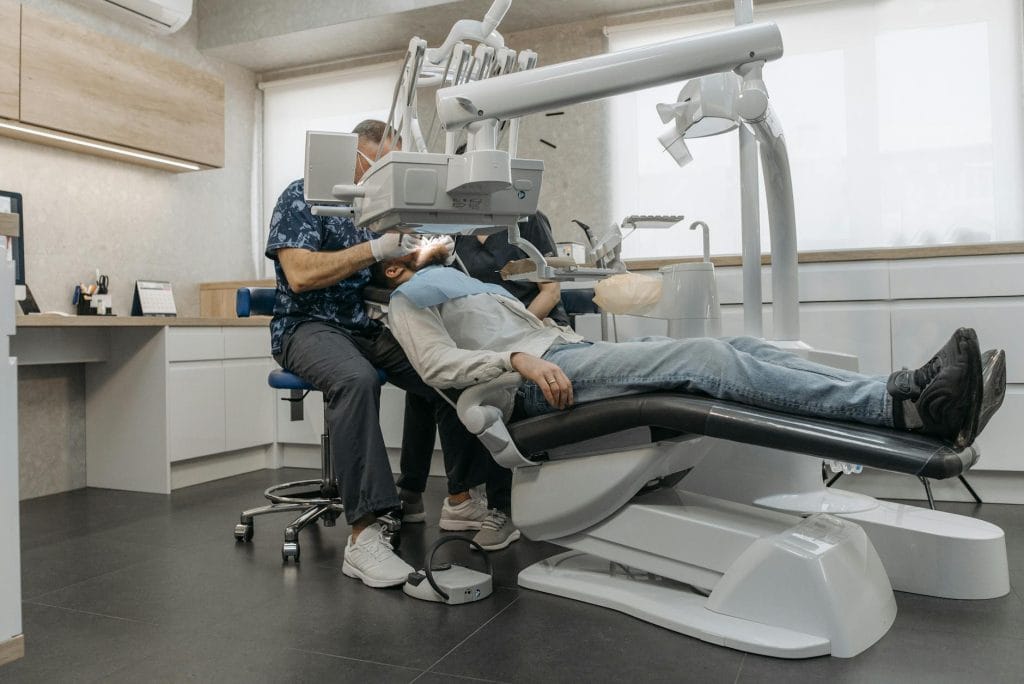 a dentist in a clinic working on a patient