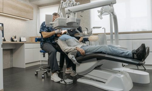 a dentist in a clinic working on a patient
